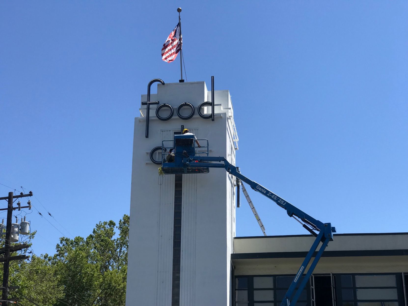 Workers installing vintage Food City letters at the south Napa center.
